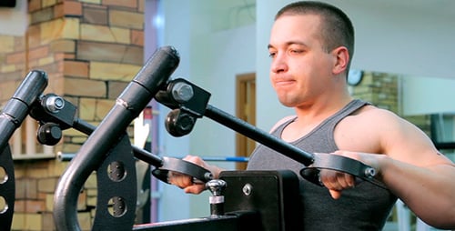 Man Exercising on Seated Row Machine in Gym