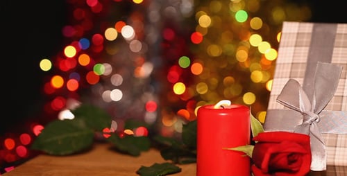 Red Candle, Rose, and Gift with Bokeh Lights