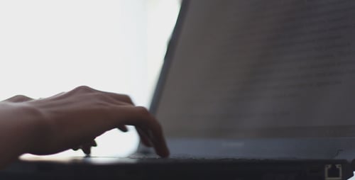 Fingers Typing on a Laptop Computer Keyboard