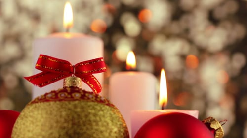 Christmas Ornaments and Candles Glowing Warmly