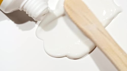 White Cream Spreading with Spatula on White Surface