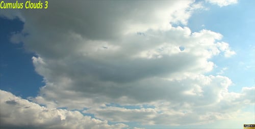 Fluffy White Clouds Moving Across Blue Sky