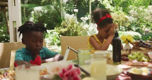 African American family spending time in garden together