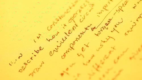 Close Up of Paper With Red Ink Writing