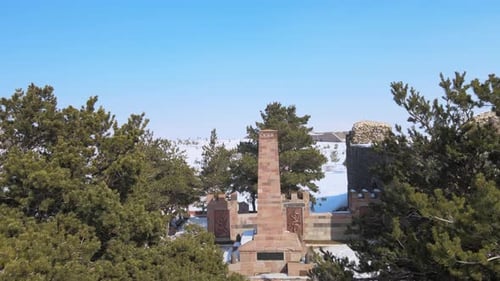 Historic Monument Surrounded By Snow Covered Trees
