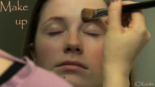 Makeup Artist Applying Foundation to Woman's Face