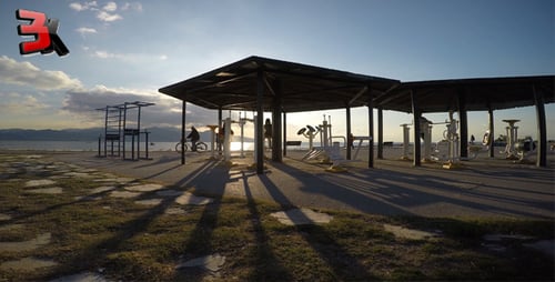 People Working Out at Outdoor Gym by the Beach