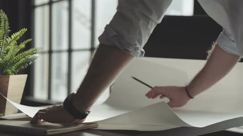 Architect with Accessories Makes Notes on the Drawing