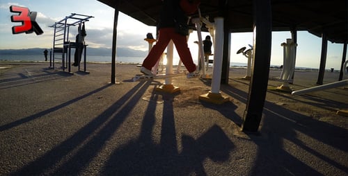 People Exercising on Fitness Equipment by the Sea