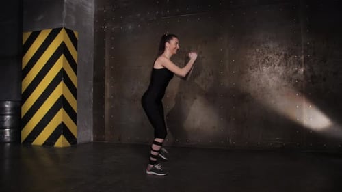 Athletic Beautiful Woman Doing Exercises in the Gym