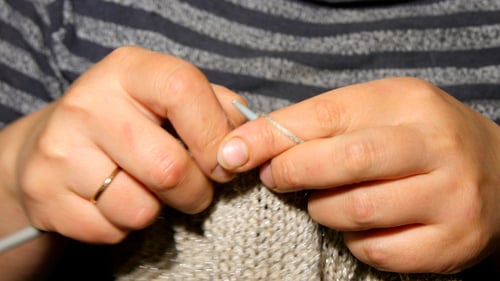 Close Up of Hands Knitting with Yarn