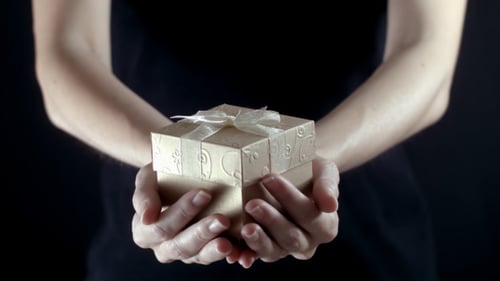 Gift held in hands, close up shot