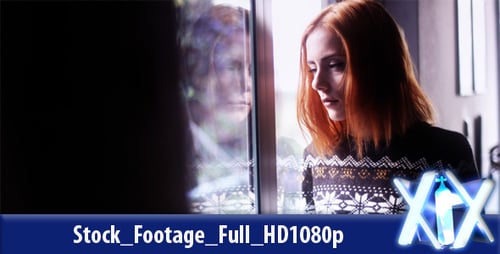 Young Woman Gazing Out Window with Contemplative Expression