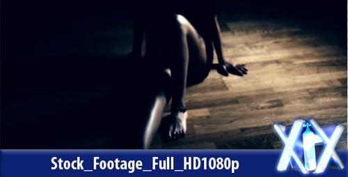 Woman Stands in Spotlight in the Darkness