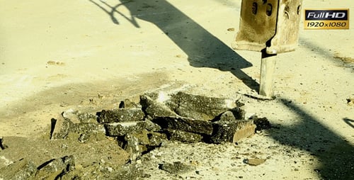 Jackhammer Breaks Asphalt on Urban Street