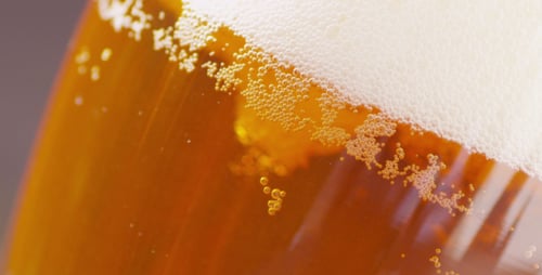 Refreshing Beer with Rising Golden Bubbles Close Up