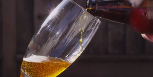 Refreshing Beer Pouring Into a Glass in Sunlight
