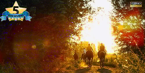 Silhouetted Riders on Horses at Golden Sunset