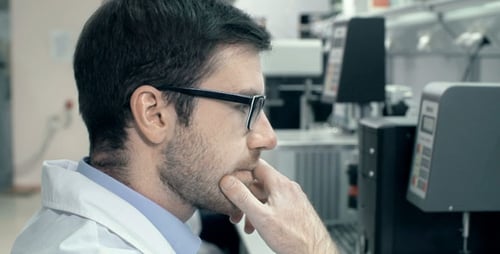 Scientist Working at Computer in Bright Modern Lab