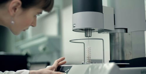 Scientist Operates Scientific Machine in Bright Laboratory