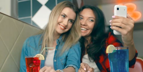 Two Young Women Taking Selfie in an Urban Setting