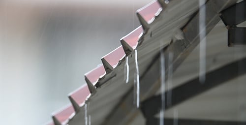Rain Water Streams off of a Roof