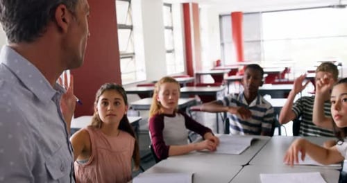 Students Raising Hands During Class Discussion