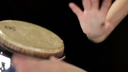 Hands Playing Bongo Drums in Close Up