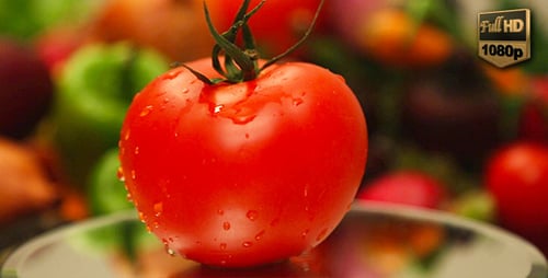 Ripe Tomato on Reflective Surface with Vegetables