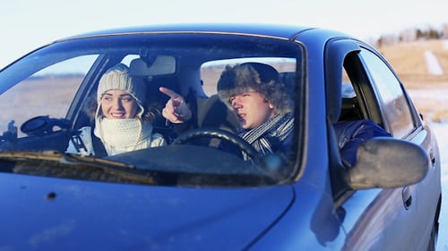 Young Couple Driving in Winter, Snowy Rural Road