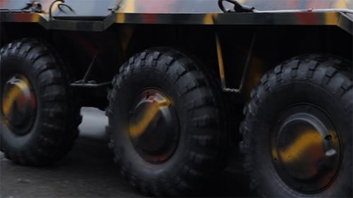 Wheels of Military Vehicle Moving on the Street