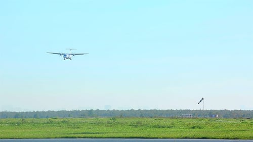 Turboprop Aircraft Landing in Open Green Field