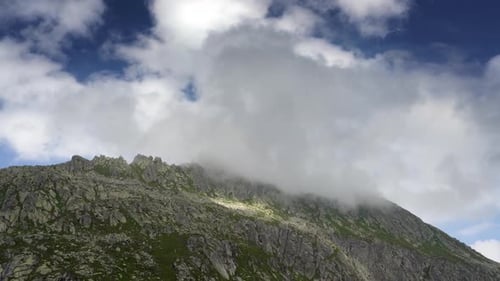 Low clouds cling to a mountain