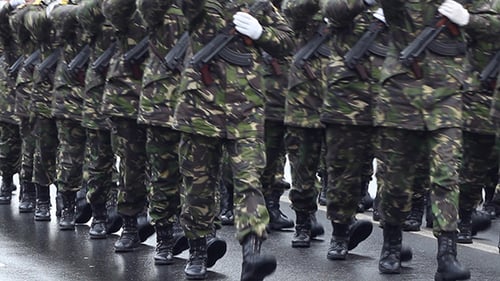 Troops Marching in Camouflage Uniforms in City
