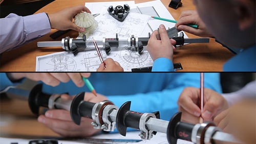 Engineers Working on Technical Design Blueprints Together