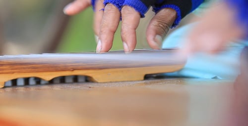 Close-up of Hands Playing a Stringed Instrument