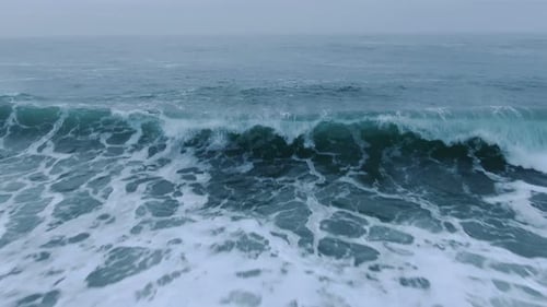 Sea Waves with Foam Roll on Sandy Beach on Nasty Day