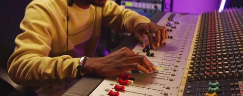 Close Up of Black Man Working with Mixing Desk in Recording Studio
