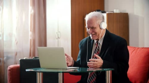Elderly Man Using Laptop for Video Call