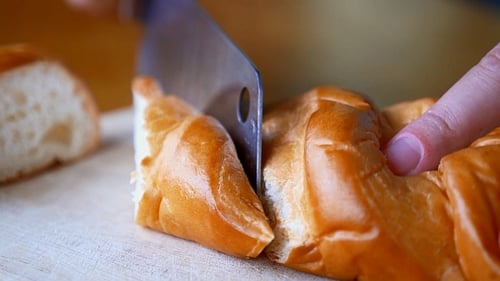 Close Up of Fresh Bread Slicing on Cutting Board