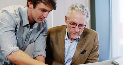 Two Men Discuss Business in Workplace