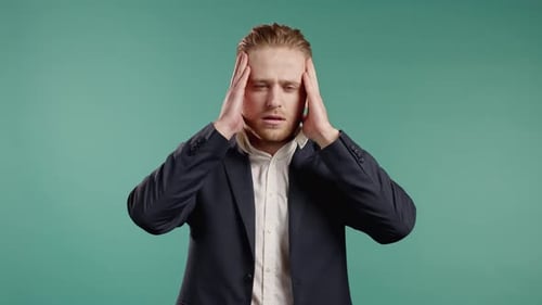 Businessman in Suit Having Headache Studio Portrait