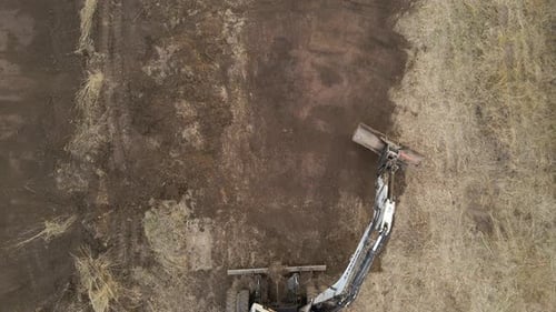 Earth Moving Tractor Preparing Place for Future House Foundation Construction