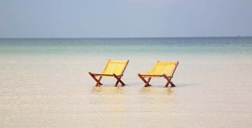 Two Beach Chairs in Shallow Tropical Water