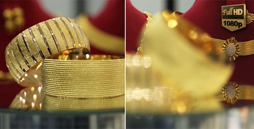 Golden Bracelets Rotating on a Jewelry Display