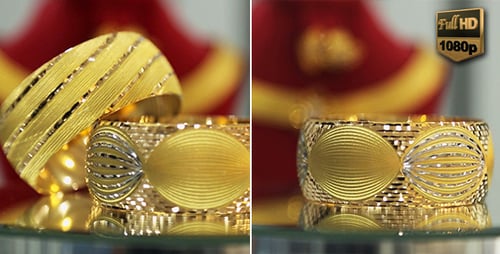 Gold Bracelets on a Reflective Surface Close Up