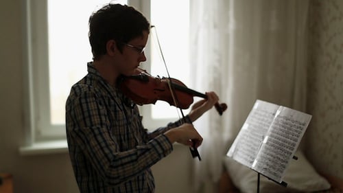 Young Adult Playing Violin Indoors