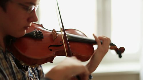 Violinist Plays Violin in Bright Room