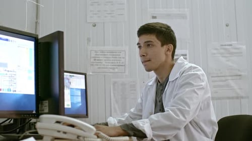 Young Adult Working on Computer in Workplace