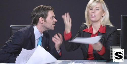 Business People Arguing at Desk in Workplace